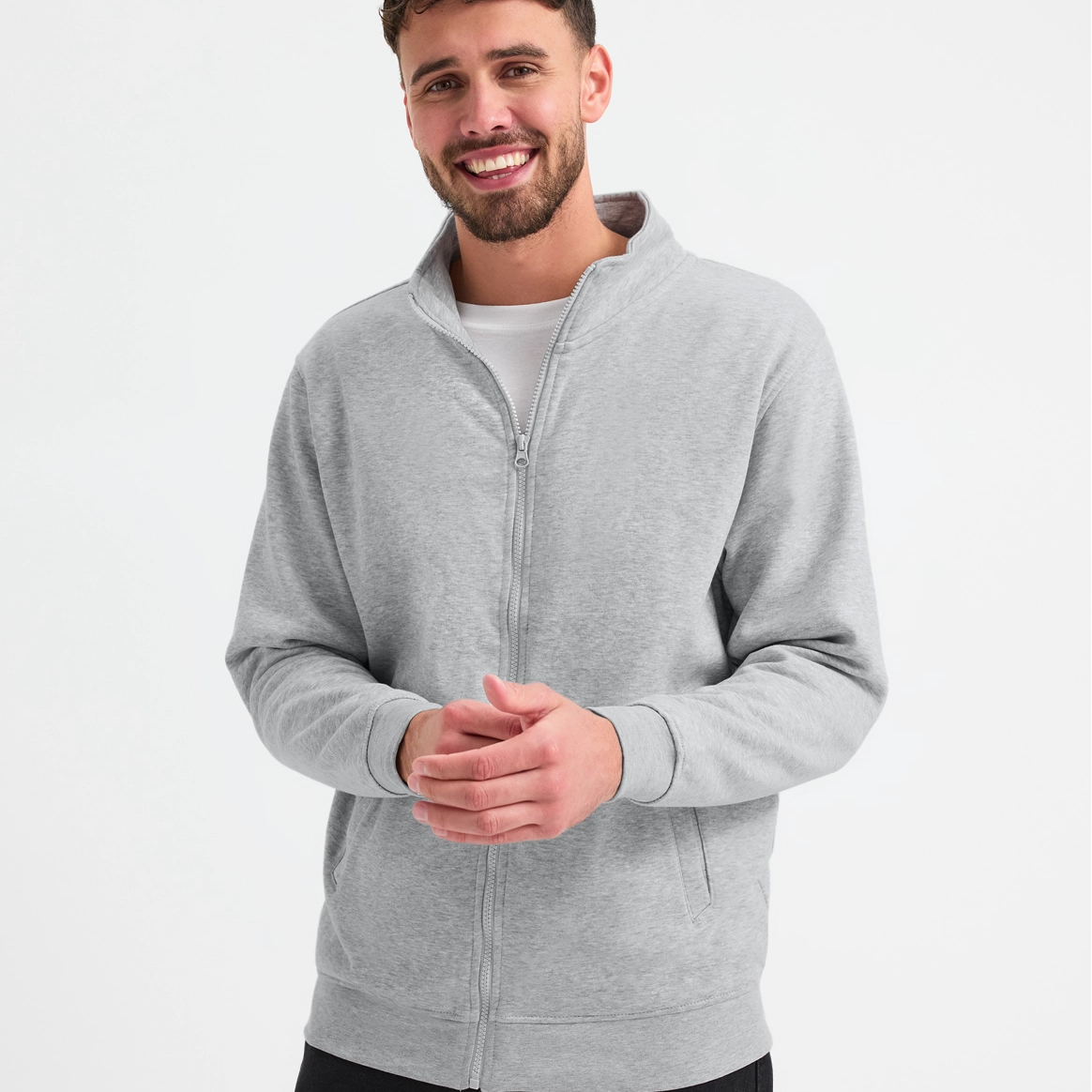 Man wearing a gray zip-up hoodie on a white background